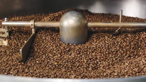 Coffee beans roasting in a large machine at a local coffee roastery during the Stock-Footage 321711569