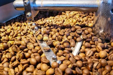Coffee beans on the roasting machine Stock Photos