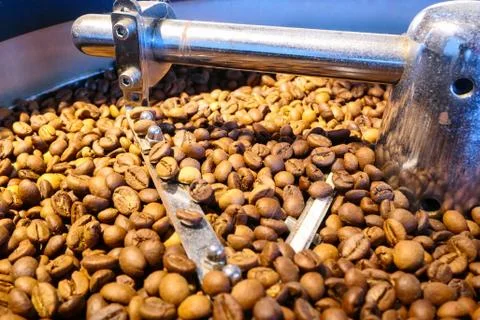 Coffee beans on the roasting machine Stock Photos