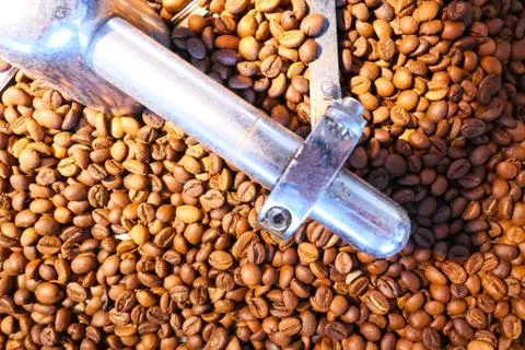 Coffee beans on the roasting machine Stock Photos