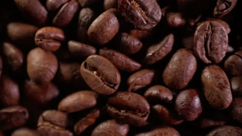 Coffee beans in the roasting process shot in close-up. smooth flight of the c Stock Footage 170865082