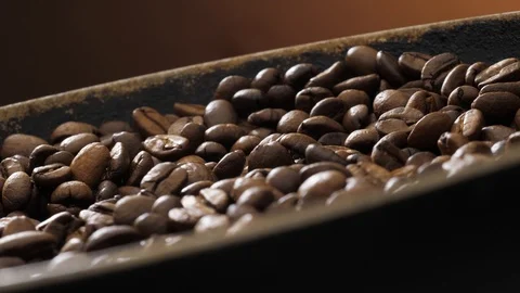 Coffee beans rotate on the pan Stock Footage 121540068