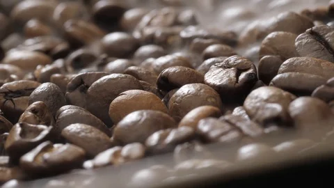 Coffee beans rotate while roasting. Smoke comes from coffee beans. Stock Footage 120203035