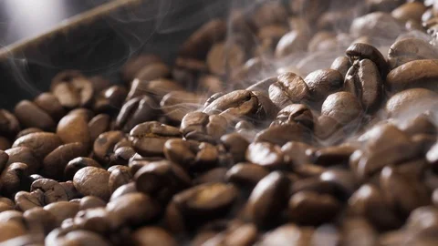 Coffee beans rotate while roasting. Smoke comes from coffee beans. Stock Footage 120371417