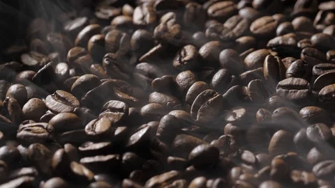Coffee beans rotate while roasting. Smoke comes from coffee beans. Stock Footage 120922267
