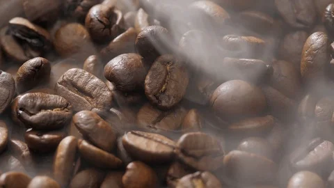 Coffee beans rotate while roasting. Smoke comes from coffee beans. Stock Footage 120922482