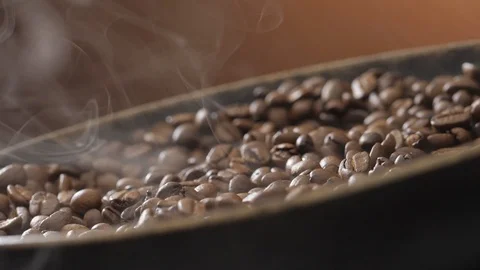 Coffee beans rotate while roasting. Smoke comes from coffee beans. Stock Footage 120922569