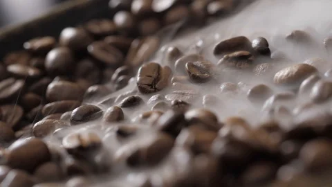 Coffee beans rotate while roasting. Smoke comes from coffee beans. Stock Footage 120922671