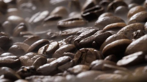 Coffee beans rotate while roasting. Smoke comes from coffee beans. Stock Footage 120983382