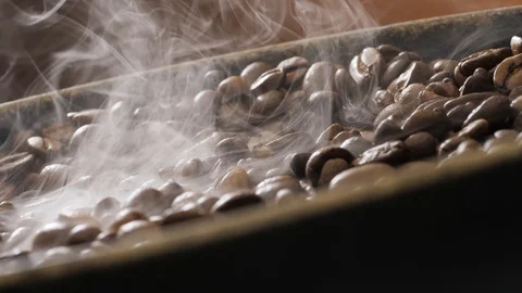 Coffee beans rotate while roasting. Smoke comes from coffee beans. Stock Footage