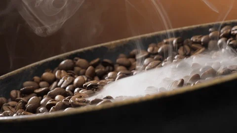 Coffee beans rotate while roasting. Smoke comes from coffee beans. Stock Footage 120984221