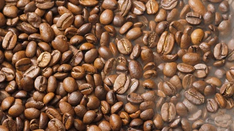 Coffee beans rotate while roasting. Smoke comes from coffee beans. Stock Footage 120984943