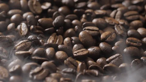 Coffee beans rotate while roasting. Smoke comes from coffee beans. Stock Footage 121229733