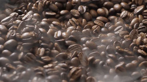 Coffee beans rotate while roasting. Smoke comes from coffee beans. Stock Footage 121229853