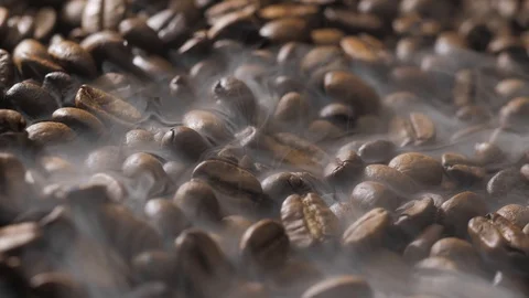 Coffee beans rotate while roasting. Smoke comes from coffee beans. Stock Footage