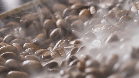 Coffee beans rotate while roasting. Smoke comes from coffee beans. Stock Footage 121540287