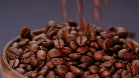 Coffee beans into rotating bowl Stock Footage 300385904