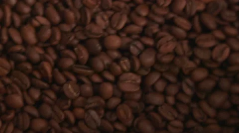 Coffee Beans Rotating in Waves Stock Footage 65784580