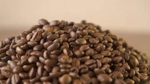 Coffee beans in rotation. Mixed Robusta and Arabica roasted Coffee beans. Co Stock Footage 154115695