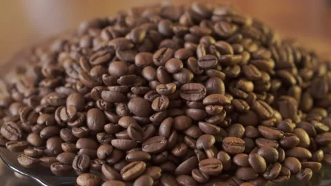 Coffee beans in rotation. Mixed Robusta and Arabica roasted Coffee beans. Co Stock Footage 154115723