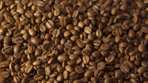Coffee beans in rotation. Mixed Robusta and Arabica roasted Coffee beans. Co Stock Footage 154115749