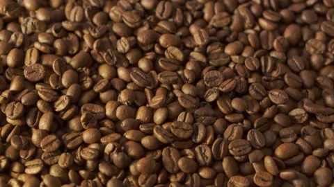Coffee beans in rotation. Mixed Robusta and Arabica roasted Coffee beans. Co Stock Footage 154115798