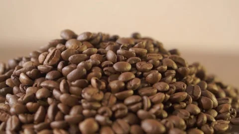 Coffee beans in rotation. Mixed Robusta and Arabica roasted Coffee beans. Co Stock Footage 195158877