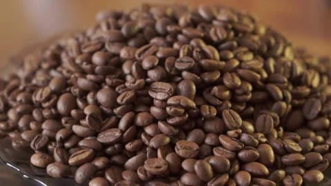 Coffee beans in rotation. Mixed Robusta and Arabica roasted Coffee beans. Co Stock Footage 195158880