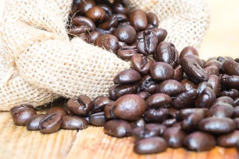 Coffee beans in sack closeup Stock Photos