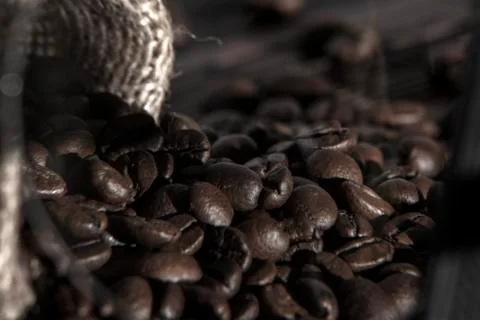 Coffee beans in sackcloth on table close up Stock Photos