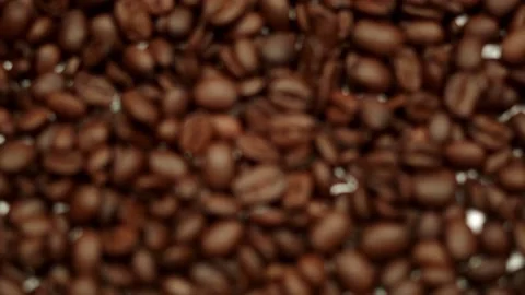 Coffee beans scattered across a white table Stock Footage 139320946