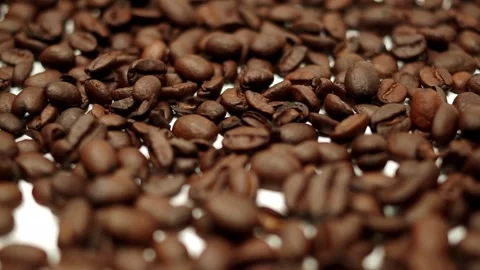 Coffee beans scattered across a white table Stock Footage 139320957