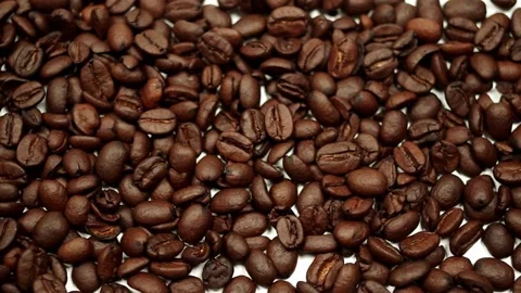 Coffee beans scattered across a white table Stock Footage 139320979