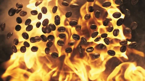Coffee beans scattered amidst flames, creating a dramatic effect. Energy and 스톡 동영상 305036537