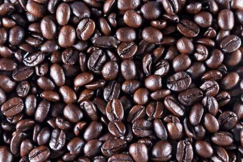Coffee beans. scattered to make background or texture. macro. Stock Photos