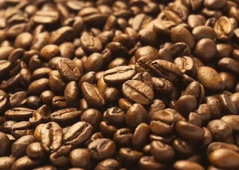 Coffee beans scattered over the surface 2 Stock Photos