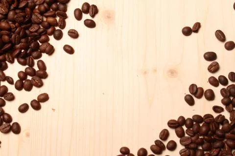 Coffee beans scattered on the table Stock Photos