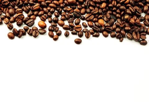 Coffee beans scattered on a white background. aromatic arabica on a background Stock Photos