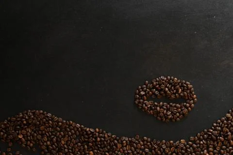 Coffee beans in the shape of a bean on dark background Stock Photos