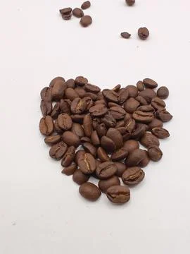 Coffee beans in the shape of a heart close up Stock Photos
