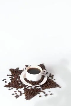 Coffee beans in the shape of a star with a cup. Top view with copyspace for y Stock Photos