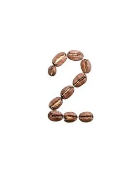 Coffee beans situated in shape of number two. Stock Photos