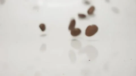 Coffee beans in slow motion bouncing past lens Stock Footage 144768521
