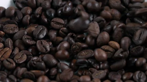 Coffee beans in slow motion fall on white background Stock Footage