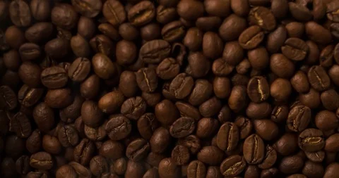 Coffee beans slow motion falling scattering and filling all screen background Stock Footage 98045756