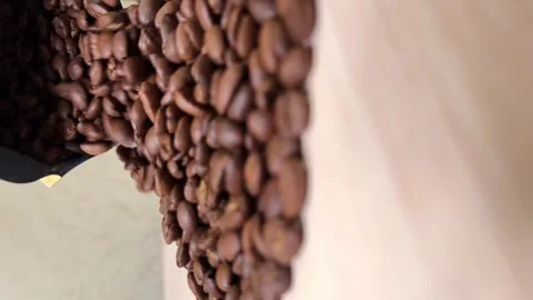 Coffee beans slowly spill out of the package onto the table Stock Footage 300090040