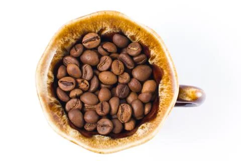 Coffee beans in a small cup on a white background. Isolated Stock Photos