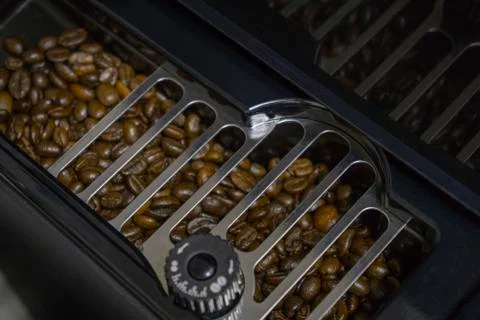 Coffee beans in the socket coffee machine Stock Photos