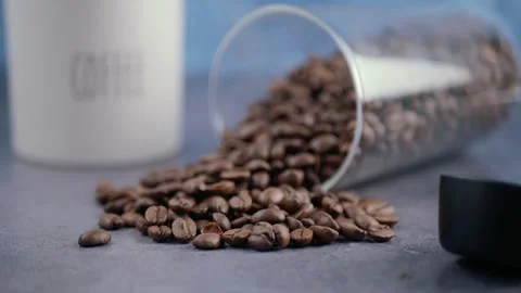 Coffee beans spill and dance in a sunny kitchen Stock Footage 338377929