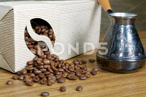 Coffee Beans Spill Out Of The Box On The Table